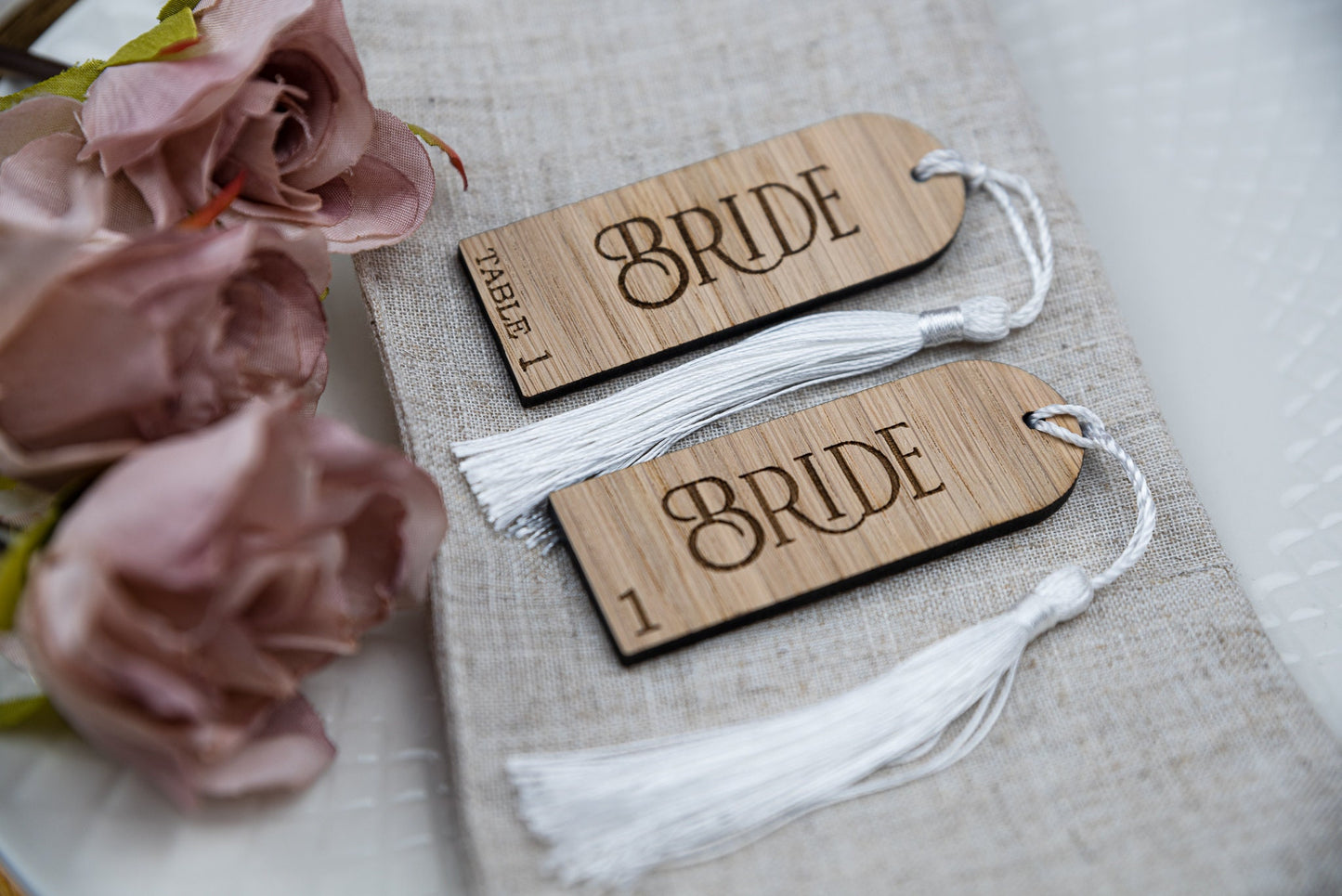 Custom engraved Oak Wooden place cards with tassels, adding a touch of elegance to any table setting. Personalised with guest&#39;s names, these unique wedding favors double as stylish table decor and guest seating assignments